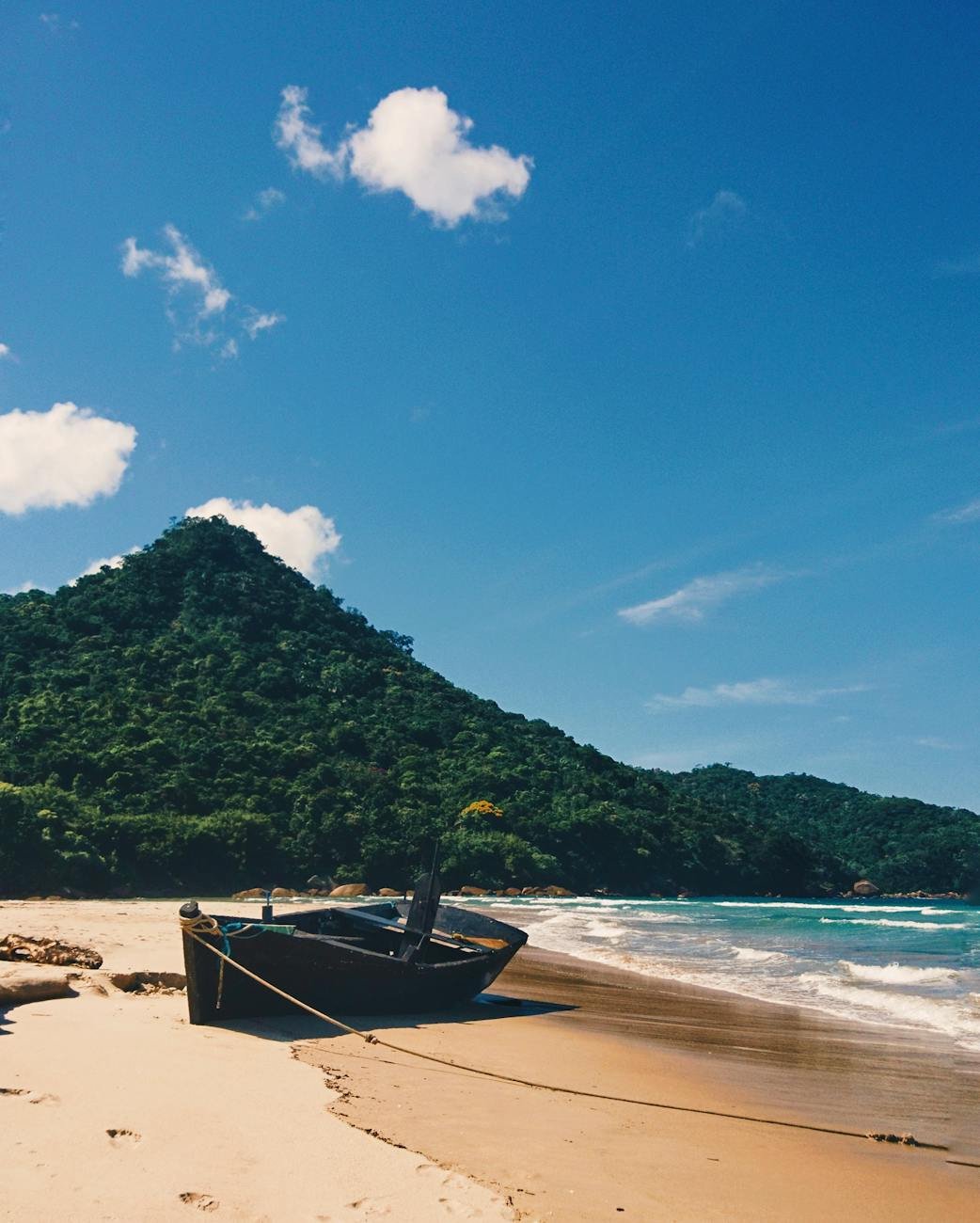 photo of wooden boat on seashore