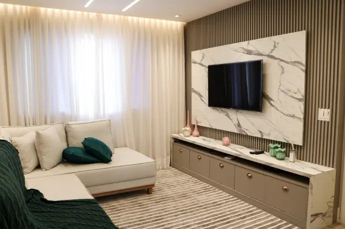 Sala cinza e branco sofisticada com painel de TV que imita mármore