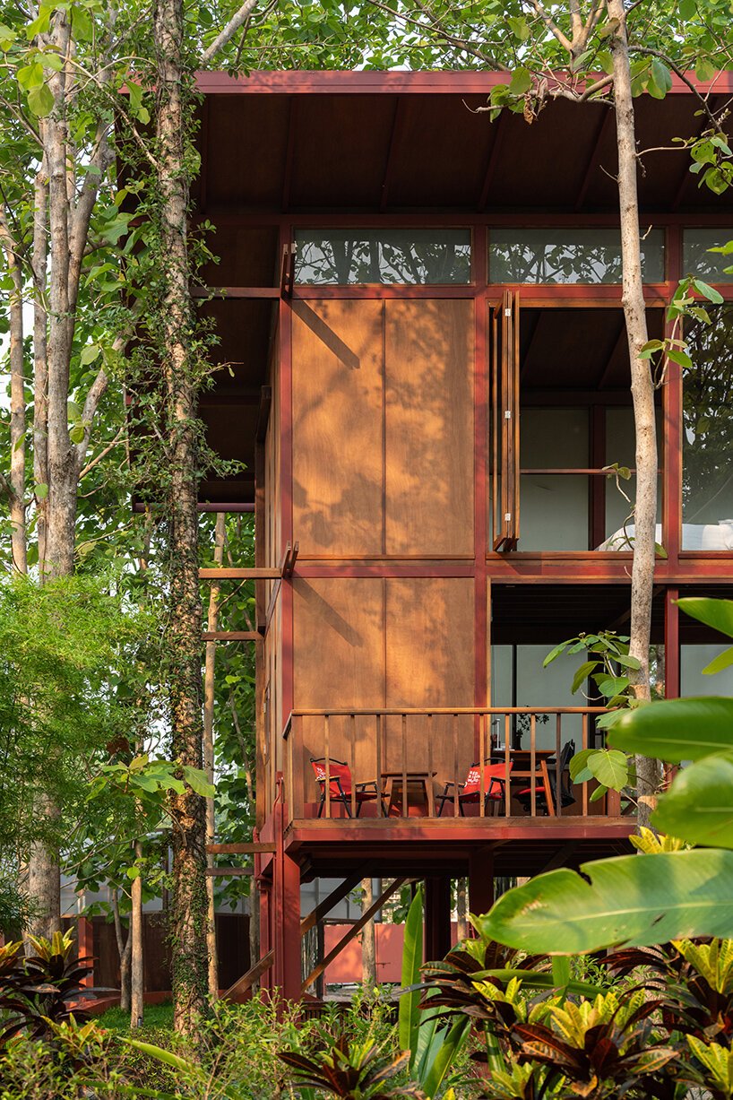 reclaimed wood and red accents define sher maker's garden lodge renovation in thailand