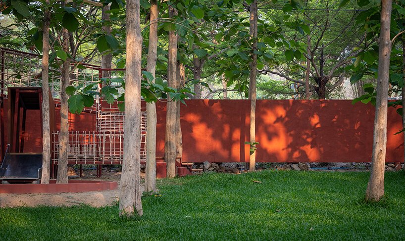 reclaimed wood and red accents define sher maker's garden lodge renovation in thailand